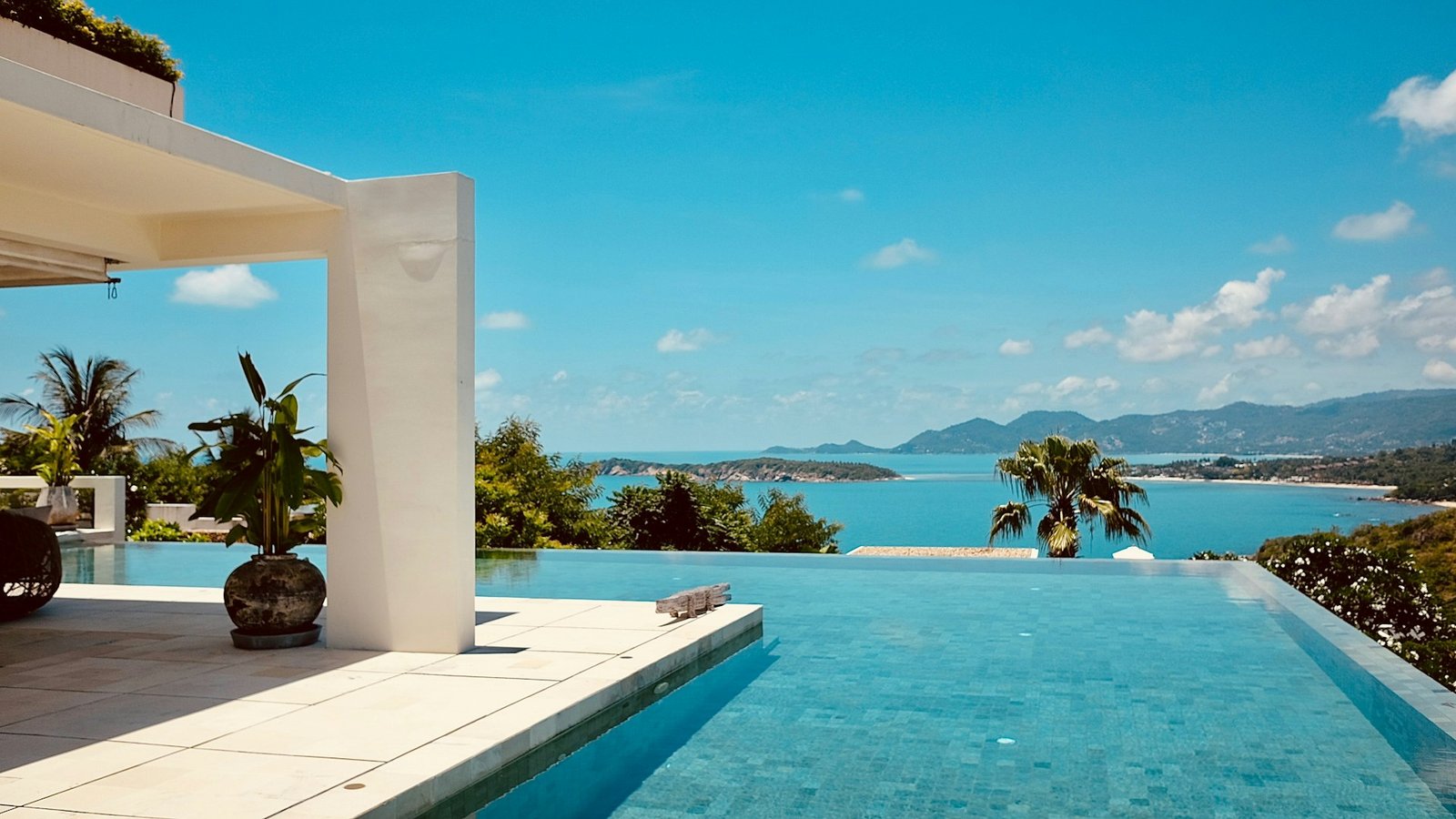 Infinity pool overlooking a blue bay